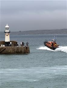 We are watching St Ives RNLI leave the harbour on a shout...